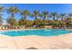 The luxurious community pool features seating and palm trees at 1713 E Bridgeport Pkwy, Gilbert, AZ 85295
