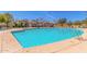 A sparkling community pool has lounge chairs around it at 1713 E Bridgeport Pkwy, Gilbert, AZ 85295