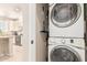 Convenient laundry area with a stacked washer and dryer, maximizing space in the home at 1713 E Bridgeport Pkwy, Gilbert, AZ 85295