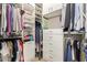 Custom walk-in closet with ample storage, shelving, drawers, and hanging space at 1713 E Bridgeport Pkwy, Gilbert, AZ 85295