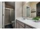 Bathroom with a single sink, large mirror, walk-in shower and a toilet at 1719 E Sandalwood Rd, Casa Grande, AZ 85122