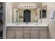 Bathroom featuring a double sink vanity with a large mirror and ample lighting at 1719 E Sandalwood Rd, Casa Grande, AZ 85122