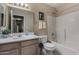 Bright bathroom featuring a shower-tub combo, neutral walls, framed mirror and a single sink vanity at 1719 E Sandalwood Rd, Casa Grande, AZ 85122