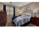 This cozy bedroom features neutral walls, artwork, and a large window providing natural light at 1719 E Sandalwood Rd, Casa Grande, AZ 85122