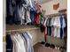 A fully stocked walk-in closet containing multiple clothing items and shelves at 1719 E Sandalwood Rd, Casa Grande, AZ 85122