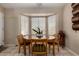 Dining area featuring a table, chairs, and natural light from the large window at 1719 E Sandalwood Rd, Casa Grande, AZ 85122