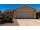 Beige exterior showing the two car garage and desert landscaping and blue sky at 1719 E Sandalwood Rd, Casa Grande, AZ 85122