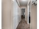 Hallway featuring closet space with a peek at the bedroom and a doorway to another room at 1719 E Sandalwood Rd, Casa Grande, AZ 85122