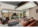 Bright living room featuring a large sectional couch and glass sliding doors opening to a pool at 1719 E Sandalwood Rd, Casa Grande, AZ 85122
