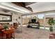 Spacious living room with backyard pool view, cozy seating, and contemporary decor at 1719 E Sandalwood Rd, Casa Grande, AZ 85122
