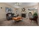 This living room features a ceiling fan, a fireplace, and comfortable seating at 1719 E Sandalwood Rd, Casa Grande, AZ 85122