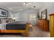 Spacious main bedroom featuring neutral walls, plush carpet, ceiling fan, and wood dresser at 1719 E Sandalwood Rd, Casa Grande, AZ 85122
