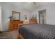 Bright main bedroom featuring wood dressers, gray comforter and ensuite bathroom at 1719 E Sandalwood Rd, Casa Grande, AZ 85122