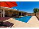 Backyard swimming pool featuring a covered patio area, perfect for relaxation at 1719 E Sandalwood Rd, Casa Grande, AZ 85122