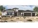 Inviting single-story home boasting a three-car garage and charming desert landscaping at 18138 E Creosote Ln, Queen Creek, AZ 85142