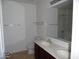 Bathroom with a double sink vanity, large mirror, and a shower/tub combo at 18548 W Sunbelt Dr, Surprise, AZ 85374