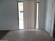 Bright room shows tiled floor and sliding glass door to patio or back yard at 18548 W Sunbelt Dr, Surprise, AZ 85374