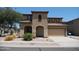 Two-story home featuring a tile roof, a neutral color scheme, and a two-car garage at 18548 W Sunbelt Dr, Surprise, AZ 85374