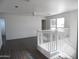 Bright living area with wood-look floors, lots of natural light, and a ceiling fan at 18548 W Sunbelt Dr, Surprise, AZ 85374