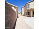 View of the backyard with gravel, block wall and partial covered patio at 1902 N 106Th Ave, Avondale, AZ 85392