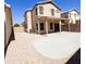 Spacious backyard showcasing partial patio, gravel, and two-story home at 1902 N 106Th Ave, Avondale, AZ 85392