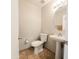Bright half-bathroom featuring pedestal sink, neutral colors, and tiled floors at 1902 N 106Th Ave, Avondale, AZ 85392