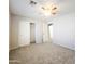 Bedroom with carpet and closet with open doors at 1902 N 106Th Ave, Avondale, AZ 85392