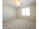 Bright bedroom featuring a ceiling fan and a large window at 1902 N 106Th Ave, Avondale, AZ 85392