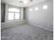Spacious bedroom with large window, carpeted floors, and recessed wall detail at 1902 N 106Th Ave, Avondale, AZ 85392