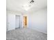 A carpeted bedroom with a ceiling fan and a closet that has sliding doors at 1902 N 106Th Ave, Avondale, AZ 85392