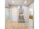 Entryway with tile floors leading to stairs, laundry room, and kitchen at 1902 N 106Th Ave, Avondale, AZ 85392