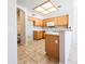 Functional kitchen featuring wooden cabinets, white appliances, and tile floors at 1902 N 106Th Ave, Avondale, AZ 85392