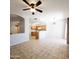 Open-concept living room with tiled flooring leading to a kitchen with wood cabinets at 1902 N 106Th Ave, Avondale, AZ 85392