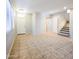Spacious living area featuring tile flooring and staircase, creating an inviting atmosphere at 1902 N 106Th Ave, Avondale, AZ 85392