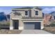Charming two-story home with a gray stucco exterior and mountain views at 2024 W Sheridan Ave, Apache Junction, AZ 85120