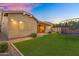 Beautiful backyard featuring a green lawn, a trampoline, a covered patio, and manicured landscaping at 20269 E Hummingbird Dr, Queen Creek, AZ 85142