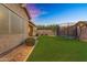 A spacious backyard featuring lush green grass, a trampoline and desert landscaping at 20269 E Hummingbird Dr, Queen Creek, AZ 85142