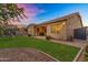 Spacious backyard with lush green lawn, covered patio, trampoline, and secure fencing at 20269 E Hummingbird Dr, Queen Creek, AZ 85142