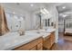 This primary bath includes double sinks, a large mirror and a shower with glass doors at 20269 E Hummingbird Dr, Queen Creek, AZ 85142