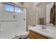 Modern bathroom with walk-in glass shower, wood-trimmed vanity, and stylish fixtures at 20269 E Hummingbird Dr, Queen Creek, AZ 85142