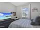 Well-lit bedroom with a window, comfortable bed, study desk, and modern decor at 20269 E Hummingbird Dr, Queen Creek, AZ 85142