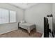 Simple bedroom featuring a single bed, closet, and plenty of natural light at 20269 E Hummingbird Dr, Queen Creek, AZ 85142