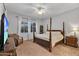This bedroom features a four poster bed, chair and dresser under windows with sheer curtains at 20269 E Hummingbird Dr, Queen Creek, AZ 85142