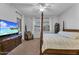 This primary bedroom features a four poster bed, TV, and natural light at 20269 E Hummingbird Dr, Queen Creek, AZ 85142