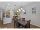 Open dining area with chandelier lighting and light wood cabinets with granite countertops at 20269 E Hummingbird Dr, Queen Creek, AZ 85142