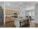 Modern kitchen features an island with seating, stainless steel appliances, and wood cabinetry at 20269 E Hummingbird Dr, Queen Creek, AZ 85142