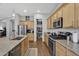 Modern kitchen with stainless steel appliances, granite countertops, and pantry at 20269 E Hummingbird Dr, Queen Creek, AZ 85142