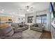 Bright living room featuring comfortable seating, natural light, and an open layout to the kitchen at 20269 E Hummingbird Dr, Queen Creek, AZ 85142