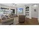 Inviting living room features built-in shelves, hardwood floors, and comfortable seating area at 20269 E Hummingbird Dr, Queen Creek, AZ 85142