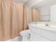 Bathroom featuring a single sink vanity, large mirror, toilet, and shower with a light brown curtain at 21 E Irvine Rd, Phoenix, AZ 85086